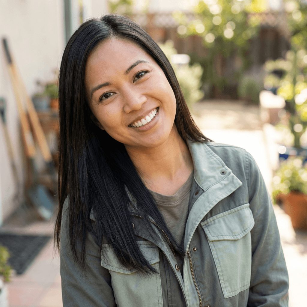 Female receptionist in her mid 20s, East Asian, friendly and approachable demeanor, professional casual style fitting a medical office